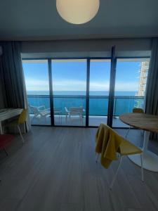 a living room with a view of the ocean at Beach Tower 33 floor, 3301 in Batumi