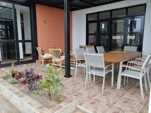 a patio with a wooden table and chairs at Vacation Home - Villa Konecta in Santiago de Cao
