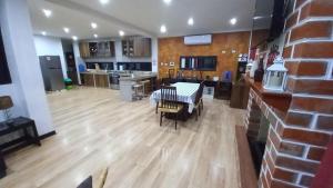 a kitchen and living room with a table and chairs at Vacation Home - Villa Konecta in Santiago de Cao