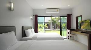 En eller flere senge i et værelse på Sritrakul Place