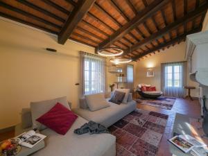 a living room with a white couch and some windows at Timeless Tuscan Holiday Stay in Arezzo