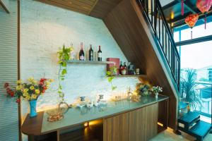 a kitchen with a counter with bottles of wine at Atypik Vietnam House in Hanoi