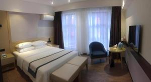 Ένα ή περισσότερα κρεβάτια σε δωμάτιο στο City Comfort Inn Yi'Ning Jichang Road Shanghaicheng