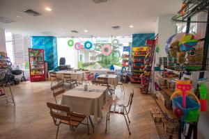 a restaurant with tables and chairs in a room at Condominio en la marina Pacifika in Los Cerritos