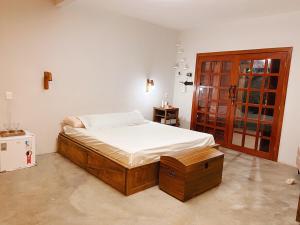 a bedroom with a large bed with a wooden frame at Casa Lajeiro in Serra de São Bento +44 photos