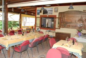 a dining room with tables and red chairs at Residence Villa Cristina in Ischia
