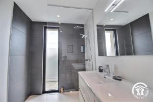 a bathroom with a shower and a sink and a mirror at Les belles vues d'erquy in Erquy +27 photos