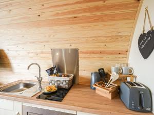 a kitchen with a sink and a counter top at Celyn Bach - Uk37083 in Llanwddyn