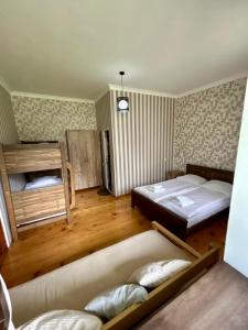 a bedroom with a bed and a couch in it at Hill House in Stepantsminda