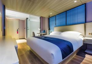 Ένα ή περισσότερα κρεβάτια σε δωμάτιο στο Echarm Hotel Guiyang Qianling Mountain +102 φωτογραφίες