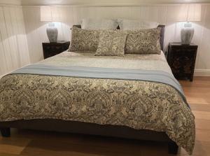 a bedroom with a large bed and two night stands at CERULEAN HOUSE - Iconic Renovated Period Home - Close to Everything in Bendigo