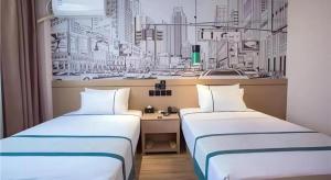 2 Betten in einem Zimmer mit Stadtzeichnung in der Unterkunft City Comfort Inn Fuyang Hongqi Middle School Erlijing Night Market in Fuyang