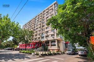 a red double decker bus parked in front of a building at Spitalul Bagdasar & Obregia - Sudului 507 by MRG Apartments in Bucharest