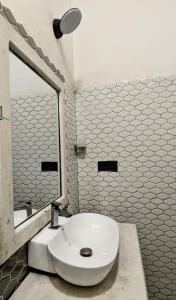 a bathroom with a white toilet and a mirror at The Village - Ella in Bandarawela