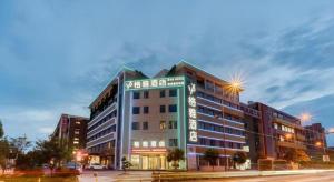 a building with a sign on the front of it at Gya Hotel Hangzhou Yuhang District Smart Town Wanda Plaza in Cangqian