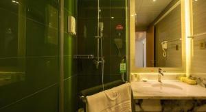 a bathroom with a sink and a shower with a mirror at Green Tree Inn Tibet Lhasa Zhaji Temple in Lhasa +41 photos