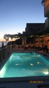 a large swimming pool with a view of the ocean at J&B Holiday House Hvar in Hvar