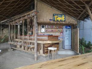 a fast food restaurant with a counter and a refrigerator at Private Beachfront Retreat in El Nido