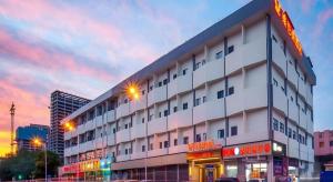 a white building with a sign on top of it at Vienna Hotel Tianjin Chentangzhuang Metro Station in Tianjin