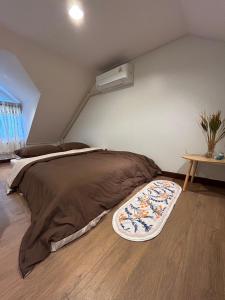 a large bed in a room with a table at Mookda House Chinatown BKK near MRT Samyot in Khlong San