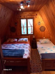 a bedroom with two beds in a cabin at Vikendica Malović in Žabljak +54 photos