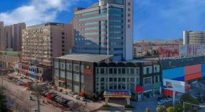 an overhead view of a city with tall buildings at Vienna Hotel Shandong Zaozhuang Qingtan Road in Zaozhuang