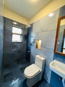 a bathroom with a toilet and a sink at Away From Home - 8 - HomeStay, Entire 2 BHK Villa in Ooty +5 photos