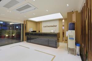 a lobby of anesthesiologist with a sign on the wall at The Ambassador in Vadodara