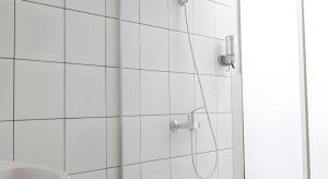 a shower with a shower head in a bathroom at Mine Home Hotel by SOVIA in Bandung +125 photos