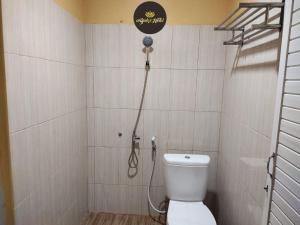 a bathroom with a toilet and a shower at Abaka Hotel Banda Aceh in Lamglumpang