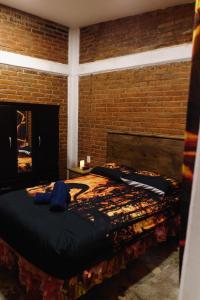 a bedroom with a large bed in a brick wall at Find Your Perfect Mountain Retreat at House fire 