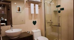 a bathroom with a toilet and a sink and a shower at Shenzhen Nan Fei Yuan Hotel in Shenzhen +25 photos
