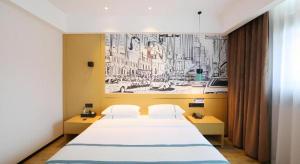 Ένα ή περισσότερα κρεβάτια σε δωμάτιο στο City Comfort Inn Enshi Nver Town