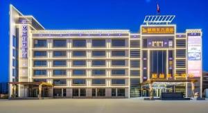 Un gran edificio blanco con un cartel en él. en GreenTree Eastern Hotel Tianjin Dongli Development Zone Xinli Metro Station, en Tianjin