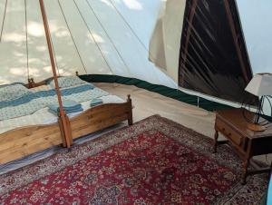 a bedroom with a bed in a tent at Séjour nature en tente équipée in Soubrebost +10 photos