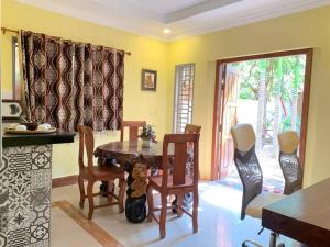 a kitchen with a table and chairs and a dining room at Dream Village in Phum Pobos