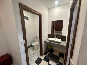 a bathroom with a sink and a toilet and a mirror at Dream Village in Phum Pobos