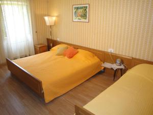 a bedroom with a large bed with yellow sheets at Authentic traditional Soca Valley home in Kanal
