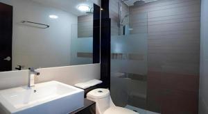 a bathroom with a sink and a toilet and a shower at Siamgrand Hotel in Ban Nong Saeng +49 photos