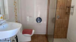 a bathroom with a toilet and a sink and a shower at Villa Thiwa Hotel in Ban Na Po Tai