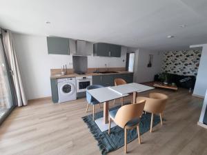 a kitchen and dining room with a table and chairs at La Villa Bellevue - 4 prs in Buissou