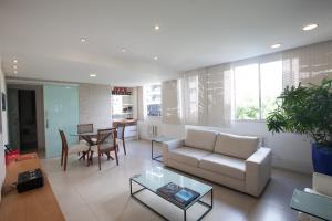 a living room with a couch and a table at The Place Leblon in Rio de Janeiro