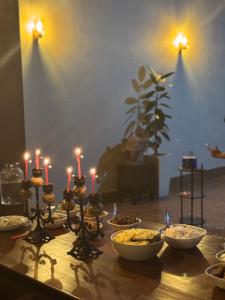 a table with candles and bowls of food on it at Rob Roy in Beruwala +1 photo