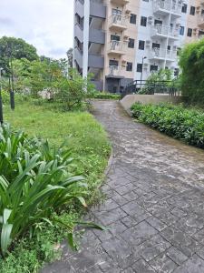 a stone path in front of a building at Hill Residences by KJA in Manila