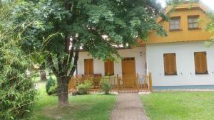 a house with a tree in front of it at Apartment Borovnica in Moravske Toplice