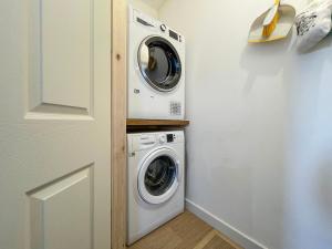 a laundry room with a washer and dryer at The Old Surgery in Kinlochbervie