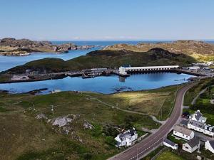 a bridge over a body of water next to a road at The Old Surgery in Kinlochbervie