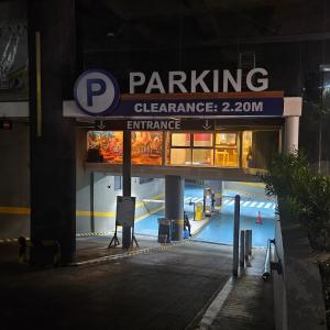 a parking sign in front of a parking garage at The ReLuxe Baguio Suite CityHub in Baguio