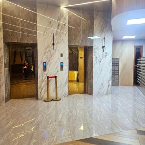 a lobby of a building with a marble wall at The ReLuxe Baguio Suite CityHub in Baguio +35 photos
