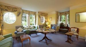 a living room with a table and chairs at Esseborne Manor in Hurstbourne Tarrant